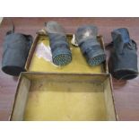 2 WW2 era gas masks in vintage suitcse