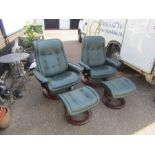 Pair of vinyl swivel chairs with foot stools