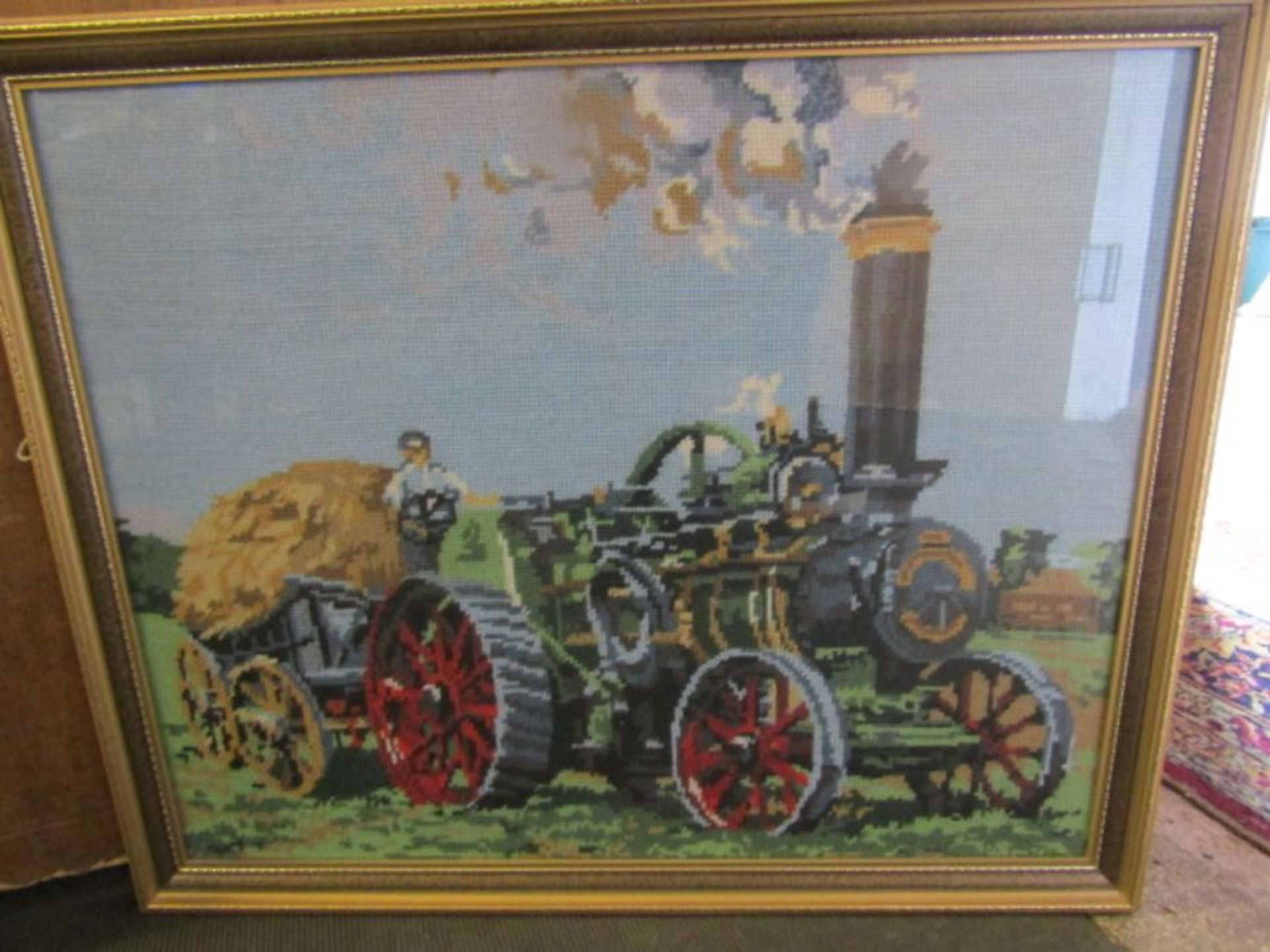 A wool work of a steam engine with hay stack