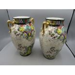 A pair of Pheonix ware vases- one has damage 24cm tall