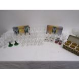 A collection of glasses inc Fleur d' lis design , hunting scene shot glasses, hock glasses etc