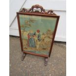 Mahogany framed fire screen with tapestry behind glass