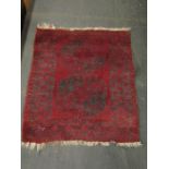 A red ground rug 113x100cm approx