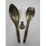 A silver caddy spoon and 2 plated Haida design salad servers