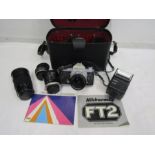 Nikkormat camera and lens in bag
