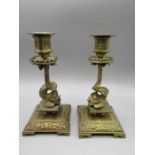 Antique brass candlesticks with fish decoration