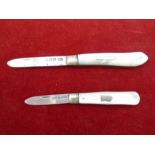 Two silver and Mother of pearl handled folding fruit knives larger one hallmarked Sheffield 1917-