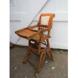 A vintage high chair- for display purposes, includes some material for seating