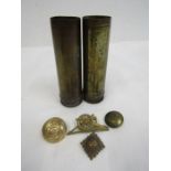 2 small trench shells along with a brooch and buttons