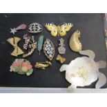 A quantity of brooches some named and a metal turtle trinket dish