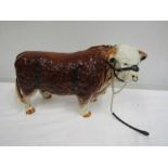 A large ceramic Hereford bull 42cm long and 29ch tall rear leg has been repaired