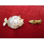 A Venetian 18ct Gold and glass fish pendant. and a Victorian pinchbeck? gloved hand necklace clasp