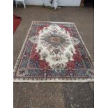 A cream/red ground Turkish wool rug 297cmL 198cmW approx. small rip see photo