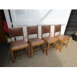 Set of 4 oak dining chairs with vinyl seats and backs, each with a plaque stating "Made at factory