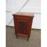 Small mahogany cupboard on legs with carved door detail