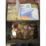 A tin of mixed coinage and couple banknotes