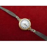 A 9ct Gold hallmarked '573' cased ladies wrist watch with leather strap (very brittle) Marked '