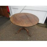 Oak tilt-top dining table in need of repair to legs as shown in photos
