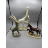 A ceramic giraffe, horses and onyx mountain goat. giraffe has damaged ear