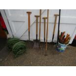Mixed garden hand tools and hoses
