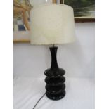 A tall black table lamp