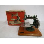 A vintage Grain miniature sewing machine in original box