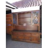 Large Oak Old Charm style dresser with 4 drawers, 4 cupboard doors and 2 glazed doors to top. (