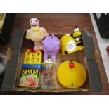 box containing seven advertising money boxes including spam, halifax, dunfermline, refuge money