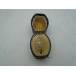 Gold Dress Ring marked 18ct with row of 5 graduating white stones (diamonds?) 2.8 gross weight and