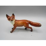 A small Beswick fox 11cm long (Tail has been broken and stuck back on)