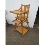 A vintage wooden high chair for display purposes only