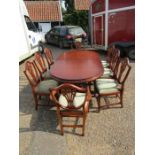 Mahogany extending dining table with 8 upholstered chairs