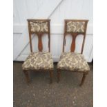 A pair of carved upholstered chairs