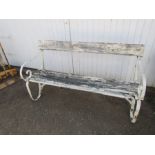 Garden bench with wrought iron ends in need of repair