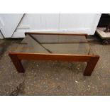 A Teak and smoked glass retro coffee table