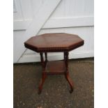 A mahogany hexagonal table with casters