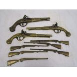 A collection of brass guns