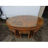 Carved softwood coffee table with glass top and 6 stools underneath