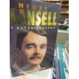 A collection of golfing books along with a Ryder cup shoe bag and a Mansell autobiography