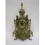 A reproduction brass ornate clock 45cm tall. quartz battery movement no glass to clock face