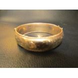 A gold bangle marked 375 9ct 26.8 grams