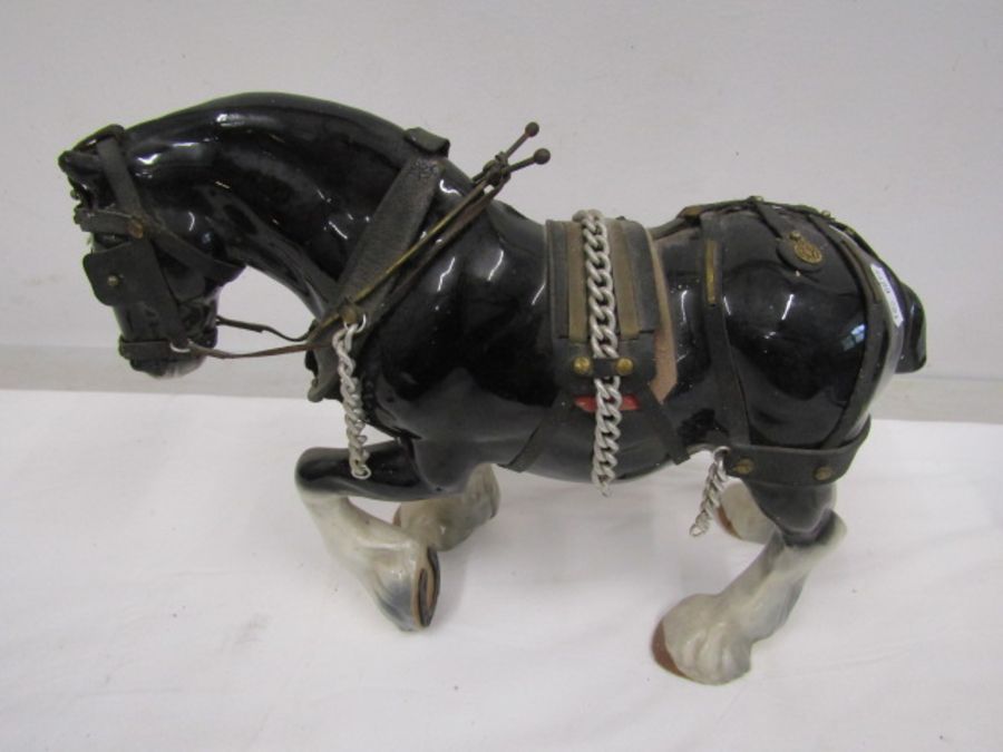 A large ceramic shire horse- leg repaired