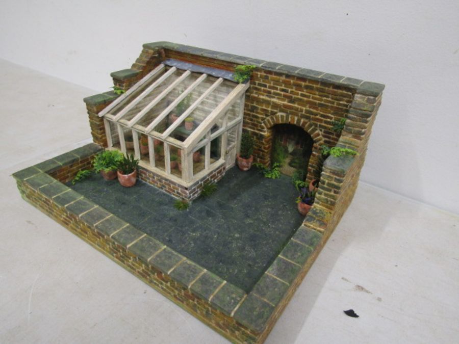 A scratch built walled garden with greenhouse made for Hampton Court Palace RHS flowershow in 1996.