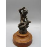 A Bronze figure of a boy on a turtles back with presentation plate on the bottom 6" tall