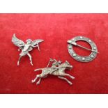 Three brooches - The Eros/Cupid brooch is marked 'silver D.H.P reg DES 853616' has Marcasite