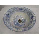 A blue and white ceramic basin with plug hole