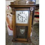 An oak case wall clock