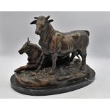 BRONZE STUDY of a standing bull by a resting cow, on a rounded oval base and marble plinth.
