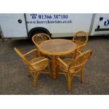 Round cane table with glass top and 4 chairs