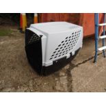 A very large pet crate with water/food holders